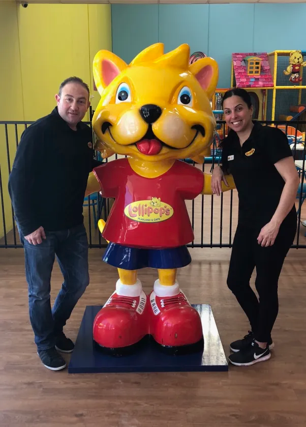 Zeina and Joe with the Lollipop's mascot inside a play centre